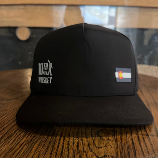 Black grooming brush with bristles on a wooden surface